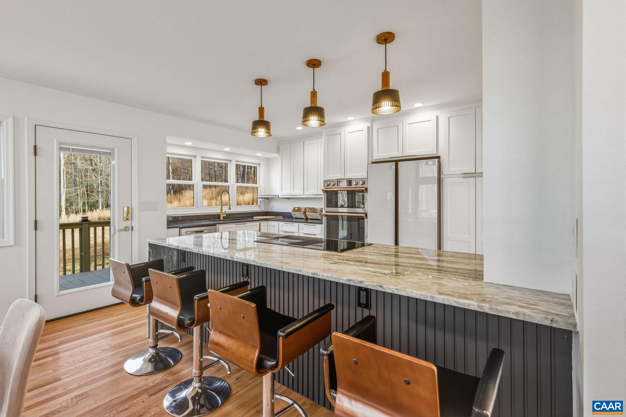 7102 Blackwells Hollow Road Crozet, VA 22932 - Photo 7 of 57 a kitchen with stainless steel appliances granite countertop a sink and a refrigerator
