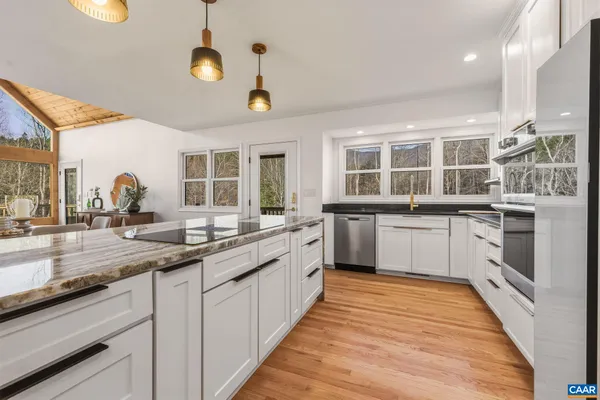a large kitchen with stainless steel appliances lots of counter space and a sink