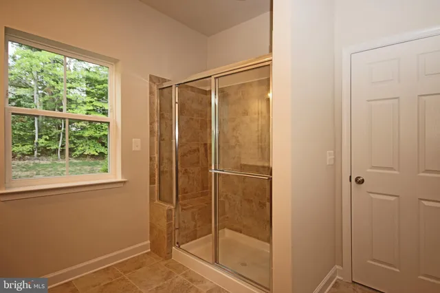 a white toilet sitting next to a white wall