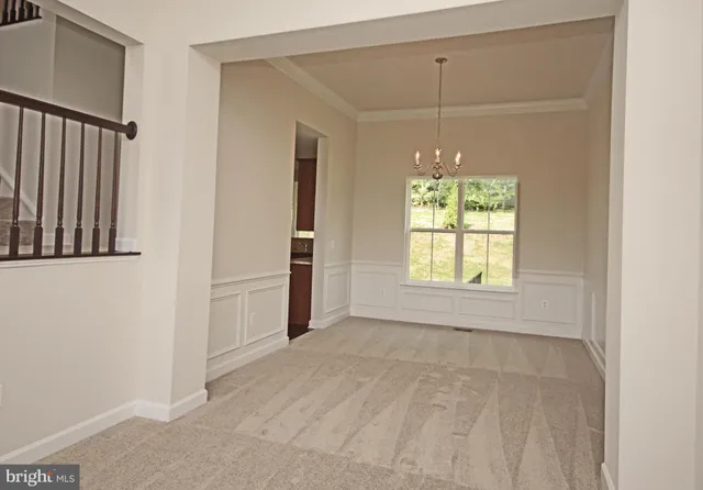 an empty room with windows and cabinet