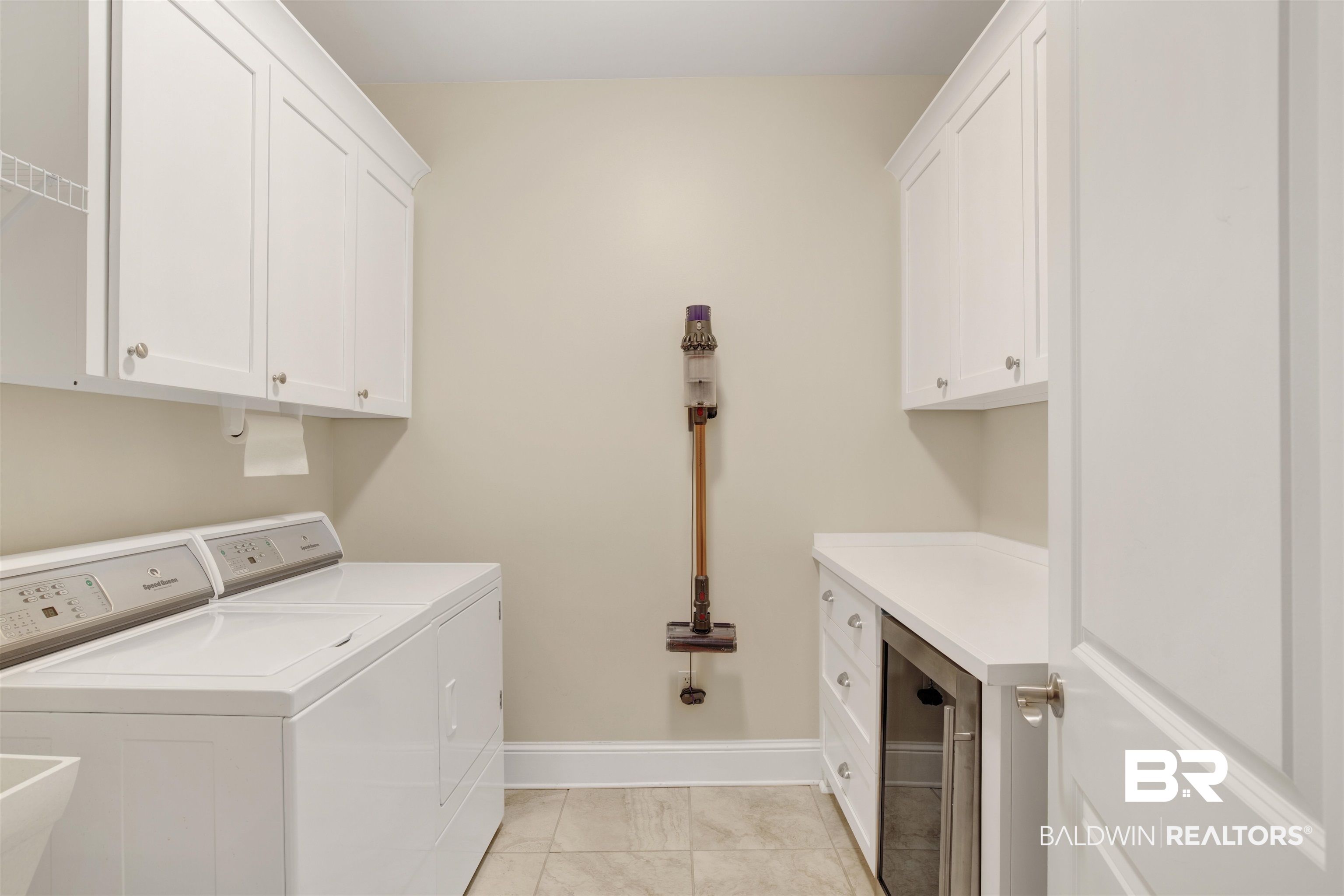 131 Sedgefield Avenue Fairhope, AL 36532 - Photo 29 of 50 Washroom with sink, cabinets, light tile patterned flooring, and wine cooler