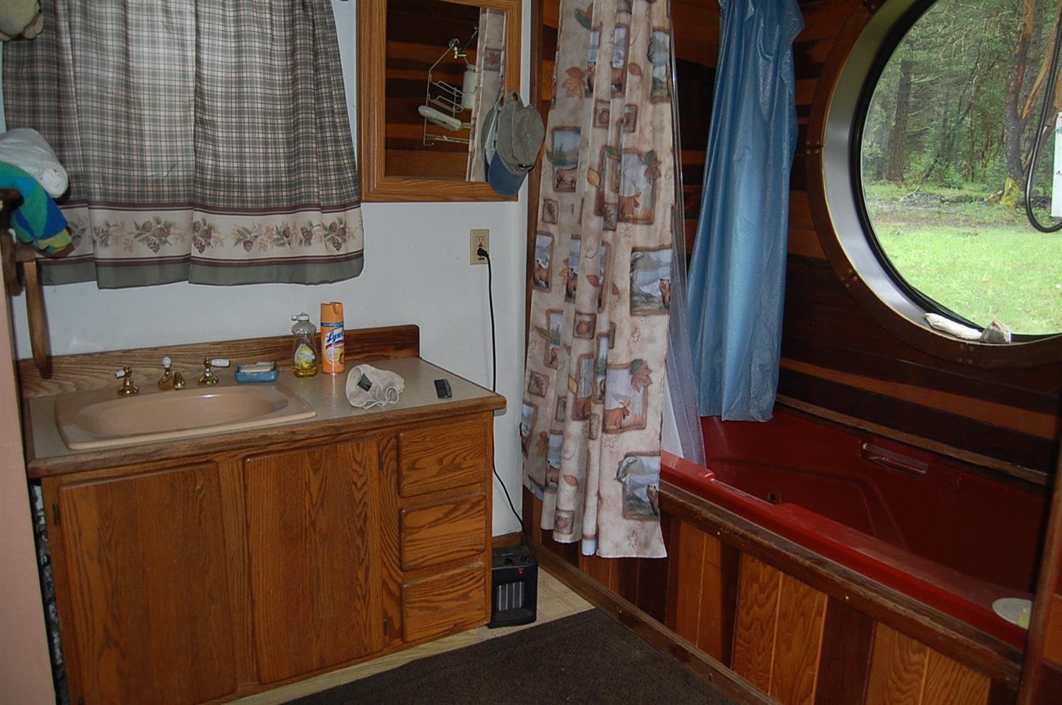 310 Page Creek Road Cave Junction, OR 97523 - Photo 16 of 31 outside bathroom with tub shower and sin