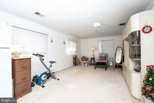a view of living room with furniture and entryway