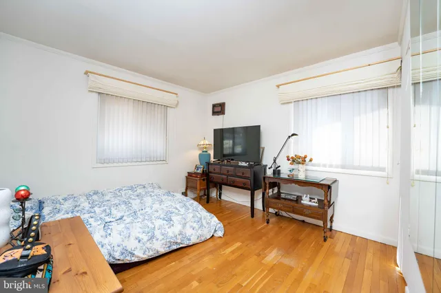 a bedroom with furniture and a wooden floor
