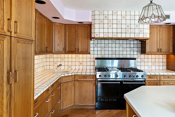 90 Holland Road Brookline, MA 02445 - Photo 17 of 35 a kitchen with a stove a sink a refrigerator and cabinets