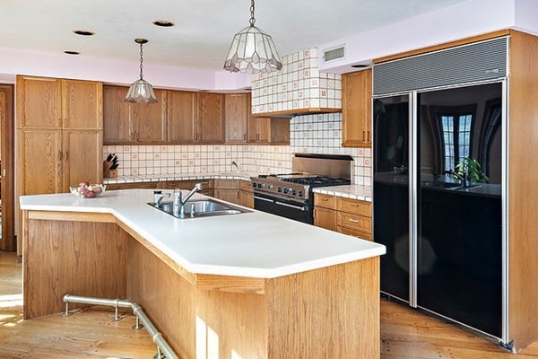 90 Holland Road Brookline, MA 02445 - Photo 19 of 35 a kitchen with a sink a stove a refrigerator and a window