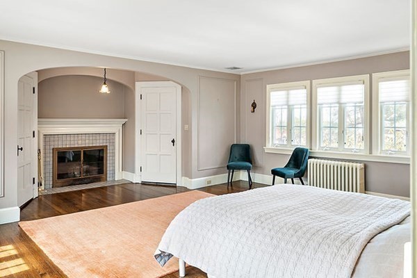 90 Holland Road Brookline, MA 02445 - Photo 23 of 35 a spacious bedroom with a bed and a fireplace