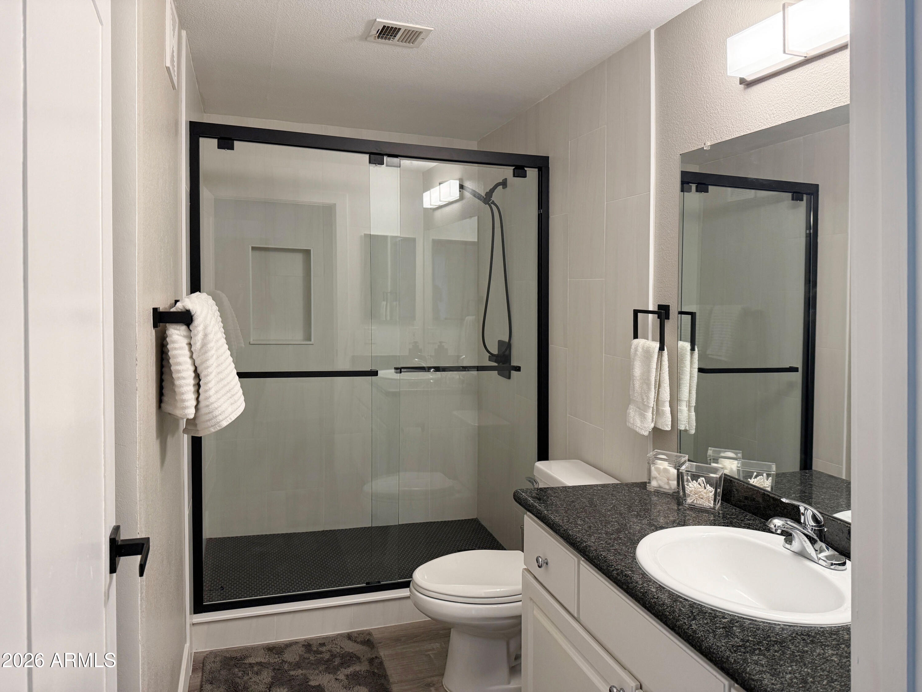 3633 North 3rd Avenue, Unit 1027 Phoenix, AZ 85013 - Photo 14 of 29 a bathroom with a granite countertop sink toilet and shower