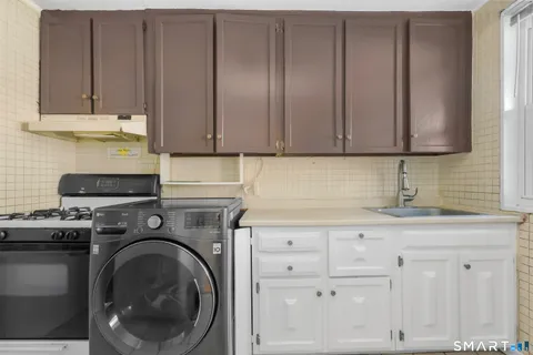 a kitchen with granite countertop cabinets and washer