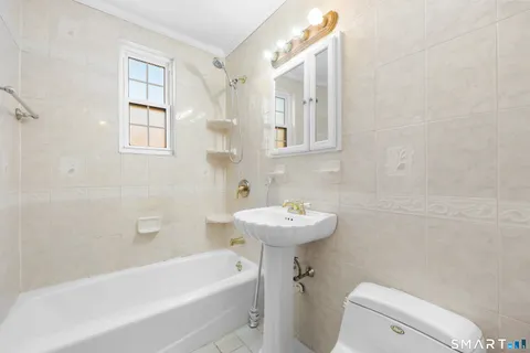 a bathroom with a sink a toilet and bathtub