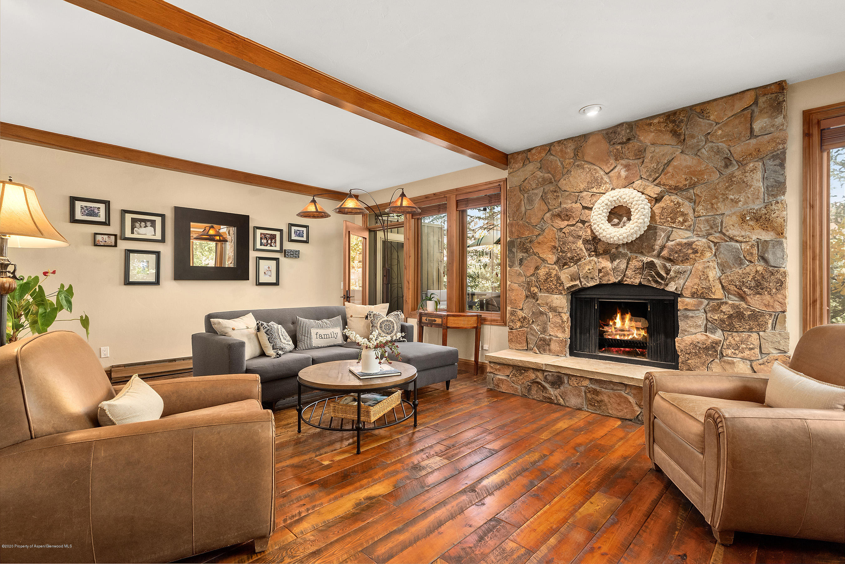 222 Meadow Ranch Road, Unit D4B Snowmass Village, CO 81615 - Photo 2 of 26 a living room with furniture and a fireplace
