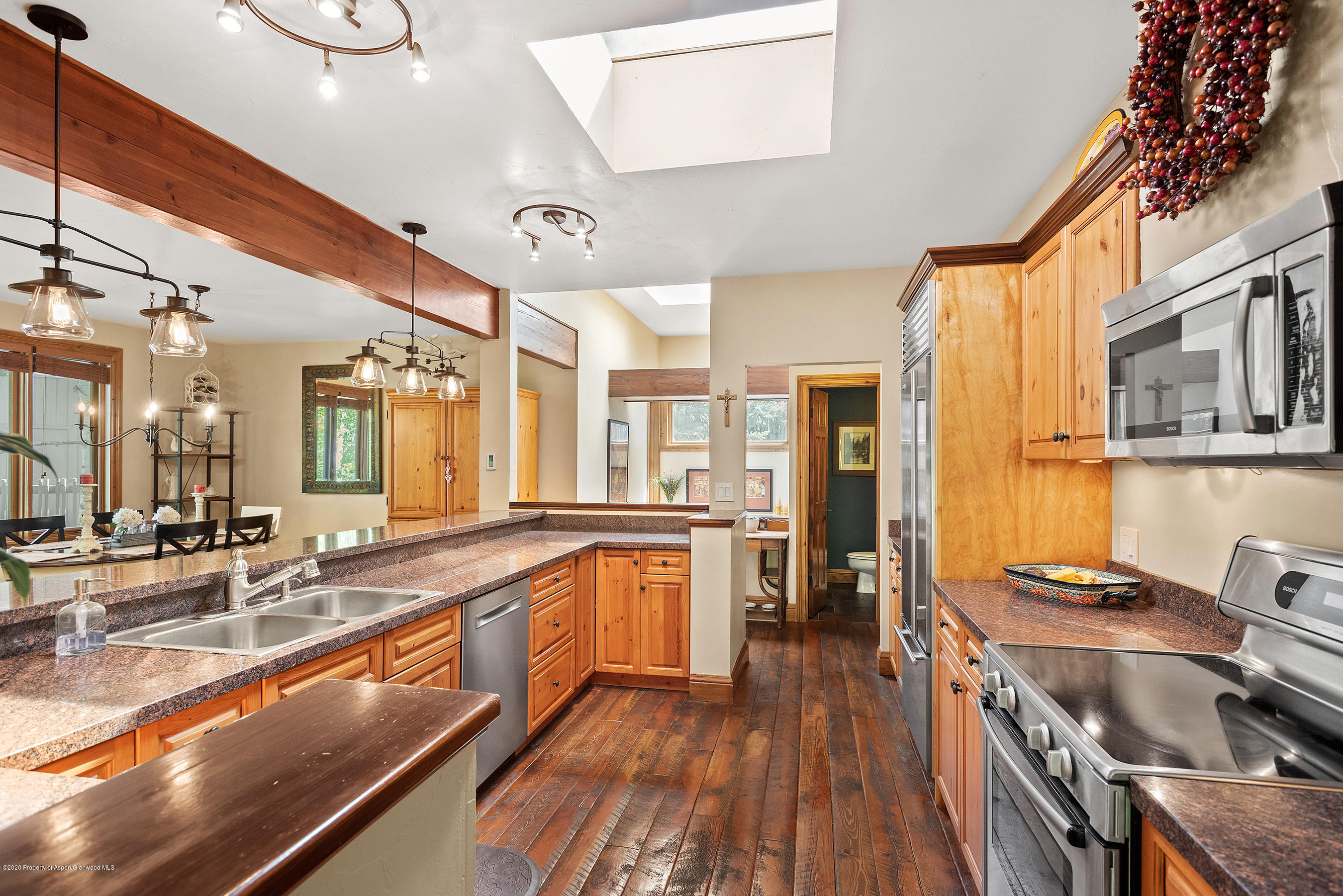 222 Meadow Ranch Road, Unit D4B Snowmass Village, CO 81615 - Photo 4 of 26 a large kitchen with stainless steel appliances granite countertop a lot of counter space and wooden floor