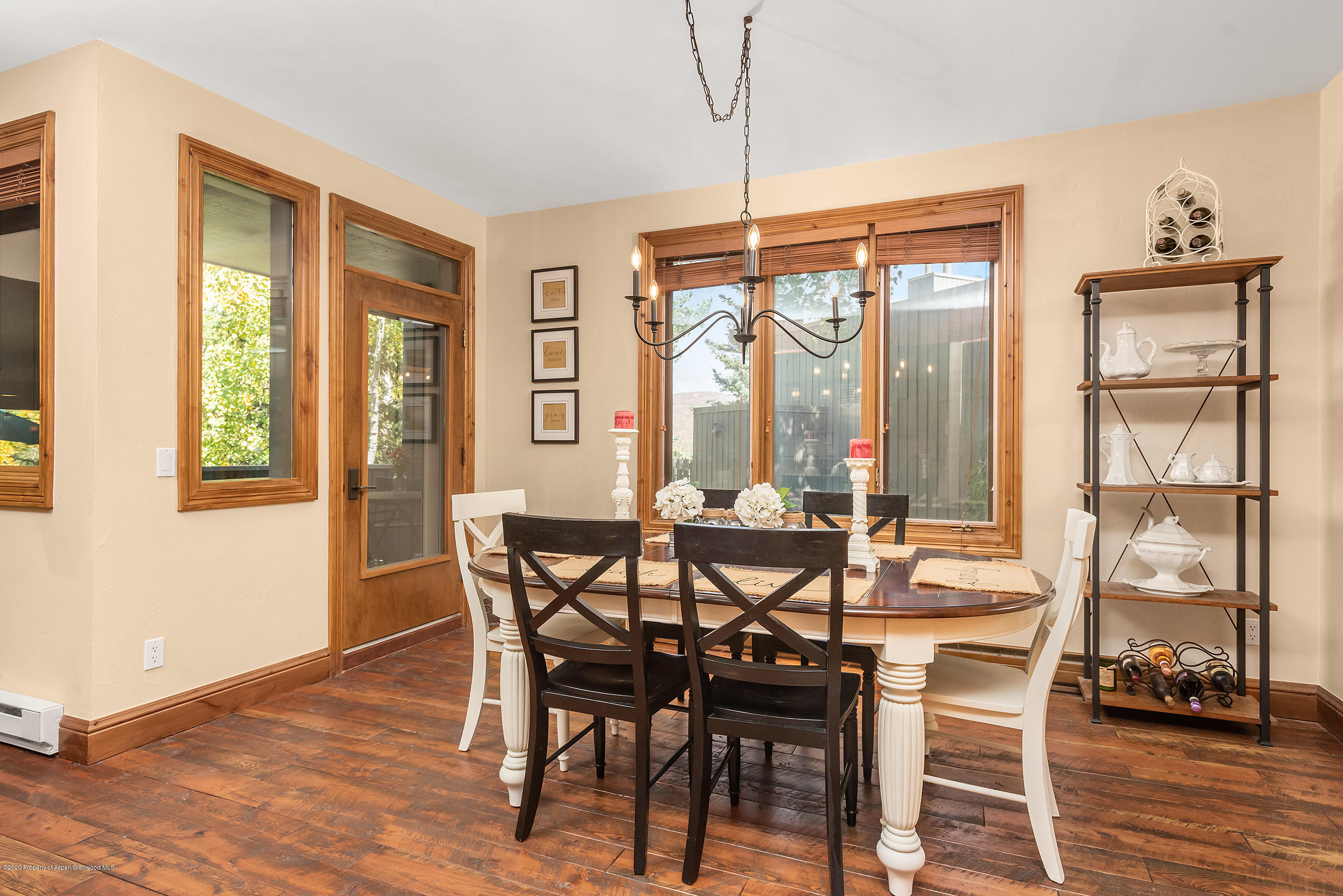222 Meadow Ranch Road, Unit D4B Snowmass Village, CO 81615 - Photo 7 of 26 a view of a dining room with furniture window and wooden floor