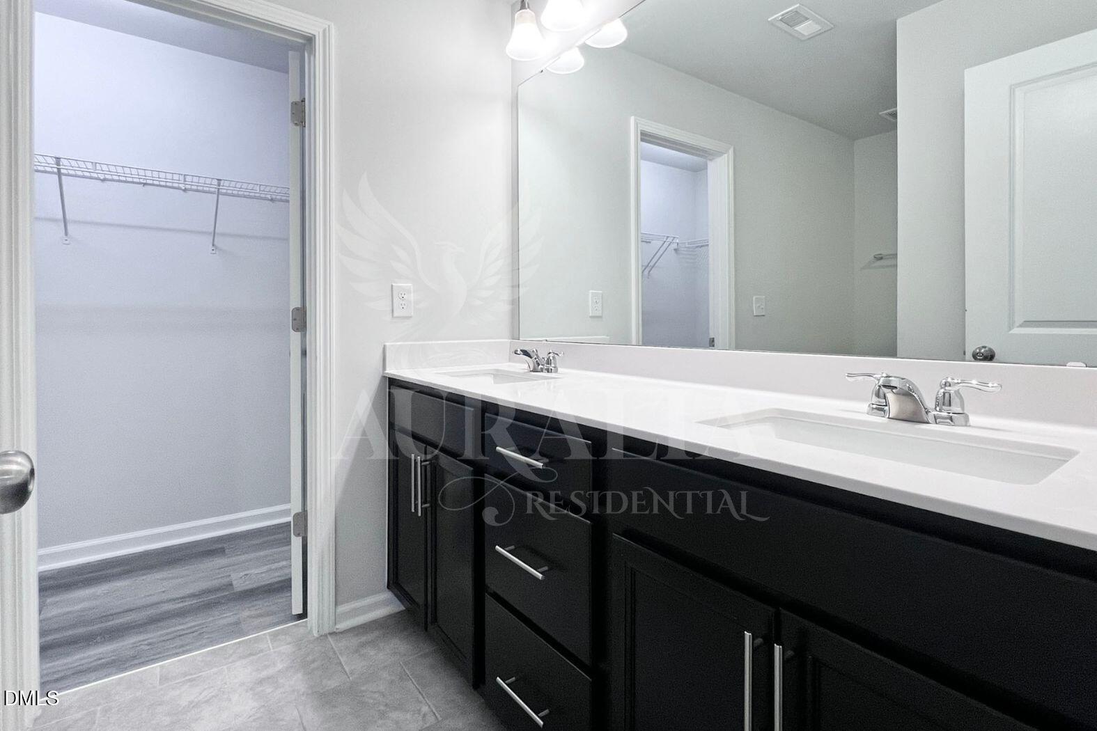 181 Ivy Vine Way Raleigh, NC 27610 - Photo 11 of 22 a bathroom with a double vanity sink and a mirror