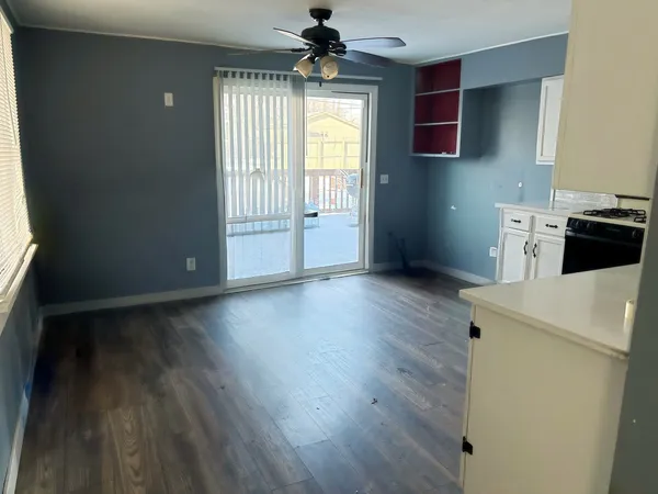 a view of kitchen with granite countertop cabinets and wooden floor
