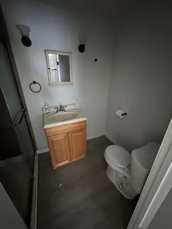 a white toilet sitting next to a bathroom sink