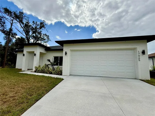 a view of a house with a yard and garage