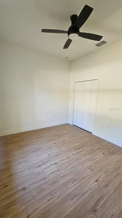 a view of an empty room and wooden floor