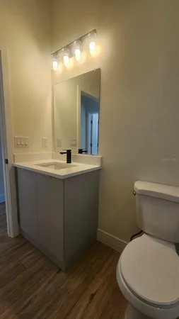 a bathroom with a toilet sink and mirror