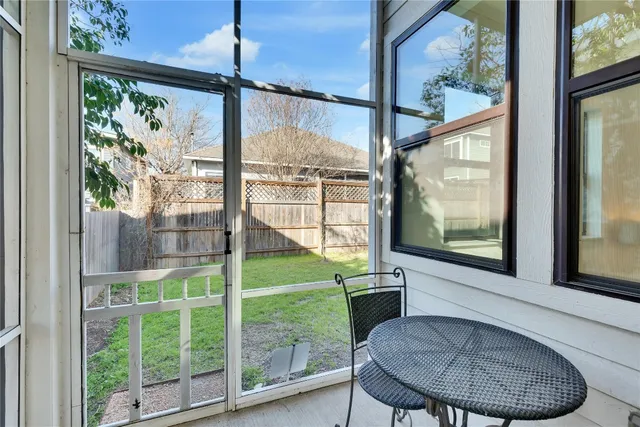 a view of a room with a large window and table
