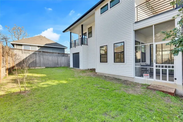 a view of a house with a yard and sitting area