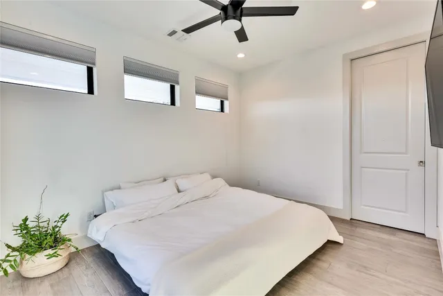 a bedroom with a bed and ceiling fan