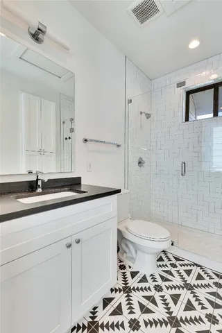 a bathroom with a sink toilet and shower