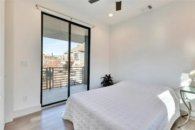 a bedroom with a large bed and a large window