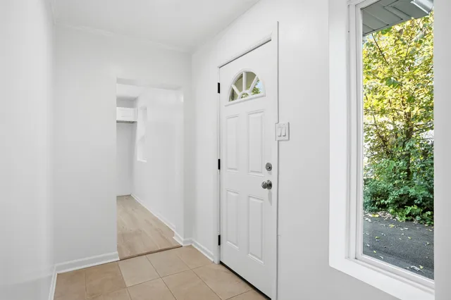 a view of an entryway with wooden floor