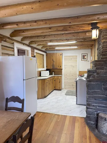 a kitchen with refrigerator and cabinets