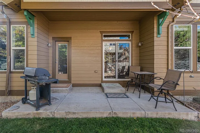 a view of a house with patio and a yard