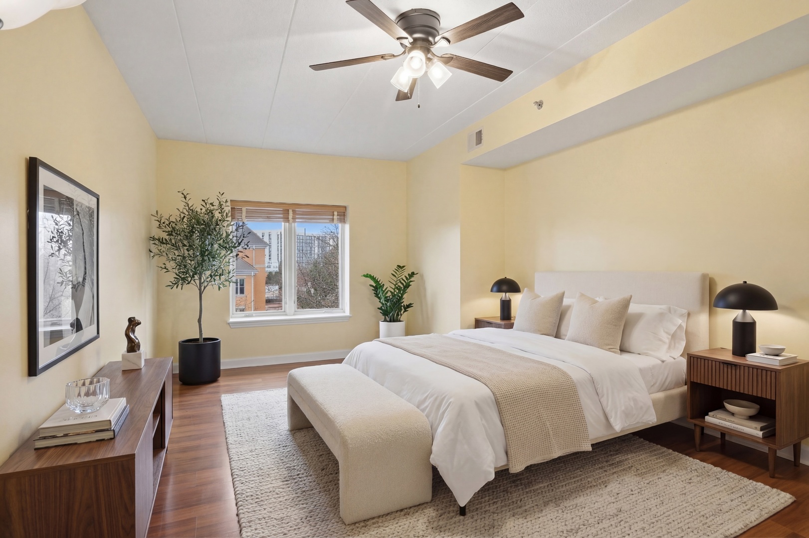 875 East 22nd Street, Unit 410 Lombard, IL 60148 - Photo 18 of 30 a bedroom with a large bed lamp and a chandelier