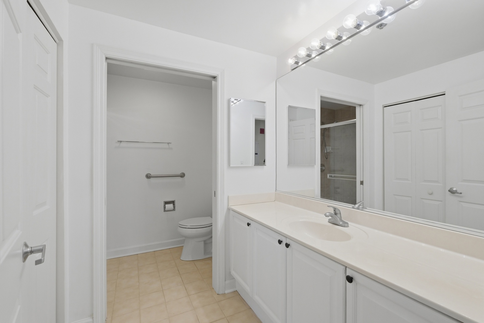 875 East 22nd Street, Unit 410 Lombard, IL 60148 - Photo 19 of 30 a bathroom with a double vanity sink toilet and shower