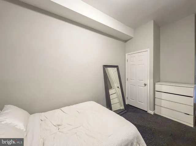 a bedroom with a bed and a dresser