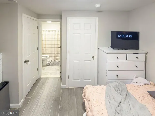 a bedroom with a bed and a view of bathroom