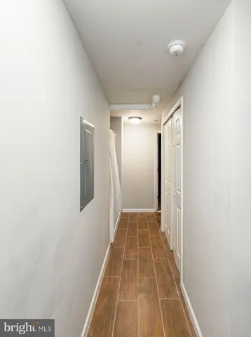 a view of a hallway with wooden floor