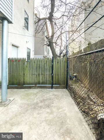a view of a yard with a wooden fence