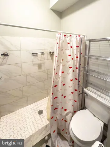a white toilet sitting next to a bathroom sink