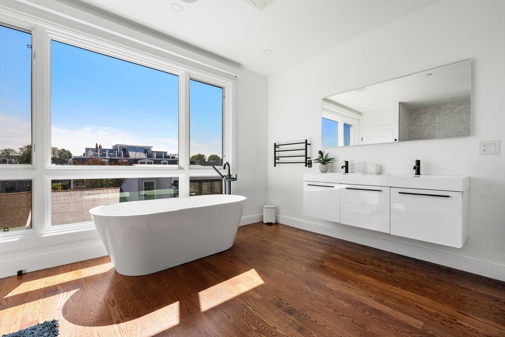 7 A Kemble Place Boston, MA 02127 - Photo 12 of 26 a living room with furniture and a large window