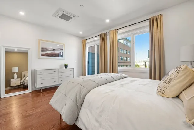 a bedroom with a large bed and a large window