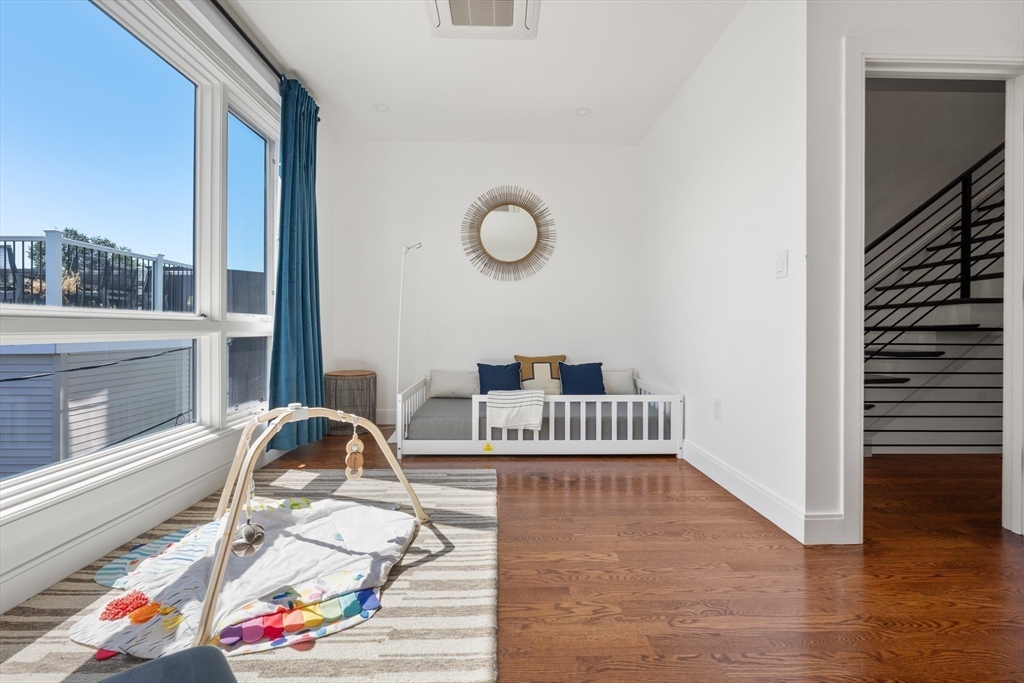 7 A Kemble Place Boston, MA 02127 - Photo 20 of 26 a view of a workspace with furniture and a floor to ceiling window