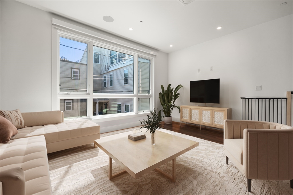 7 A Kemble Place Boston, MA 02127 - Photo 2 of 26 a living room with furniture and a flat screen tv