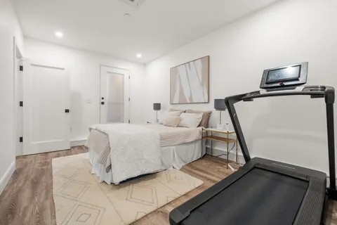 a room with a bed and a flat screen tv