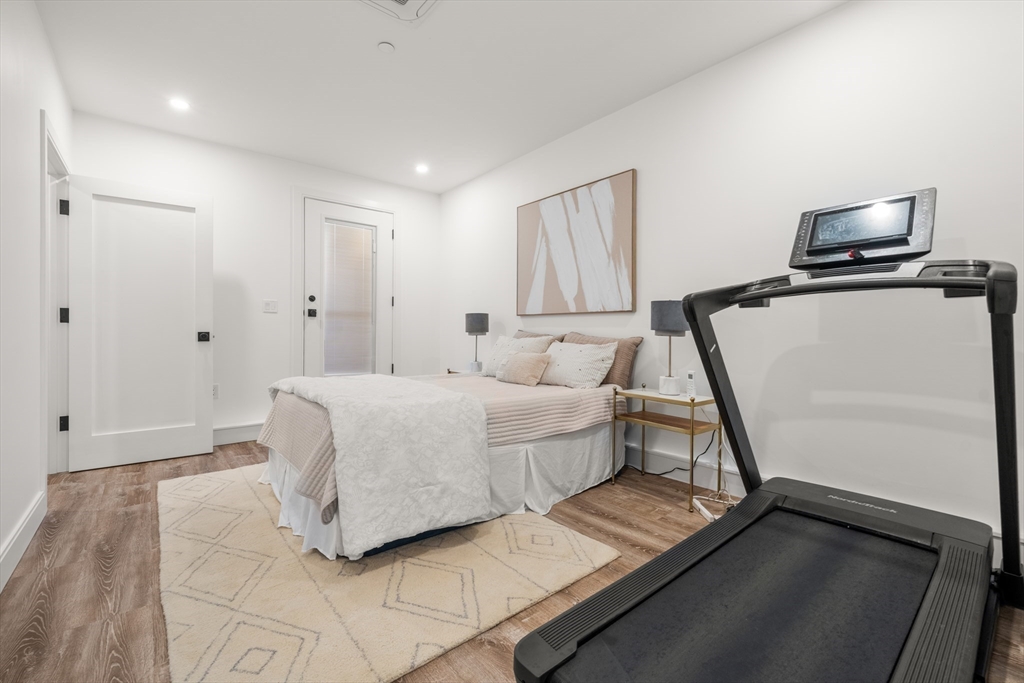 7 A Kemble Place Boston, MA 02127 - Photo 23 of 26 a room with a bed and a flat screen tv