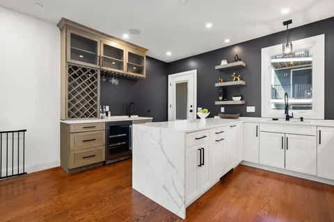 a kitchen with white cabinets and white appliances