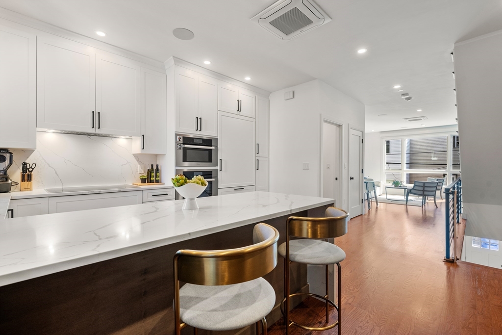 7 A Kemble Place Boston, MA 02127 - Photo 7 of 26 a kitchen with stainless steel appliances a sink and a refrigerator