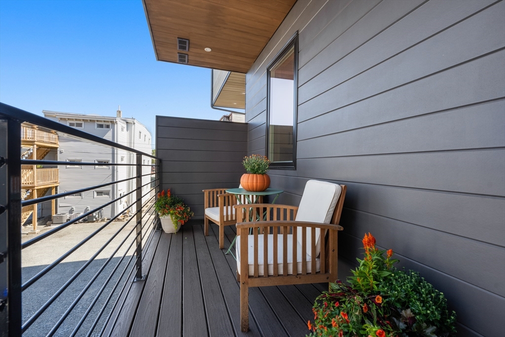 7 A Kemble Place Boston, MA 02127 - Photo 8 of 26 a view of balcony with wooden floor and potted plants