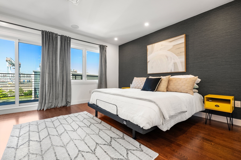 7 A Kemble Place Boston, MA 02127 - Photo 9 of 26 a bedroom with a bed and wooden floor