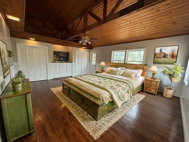 a spacious bedroom with a bed a couch and a desk