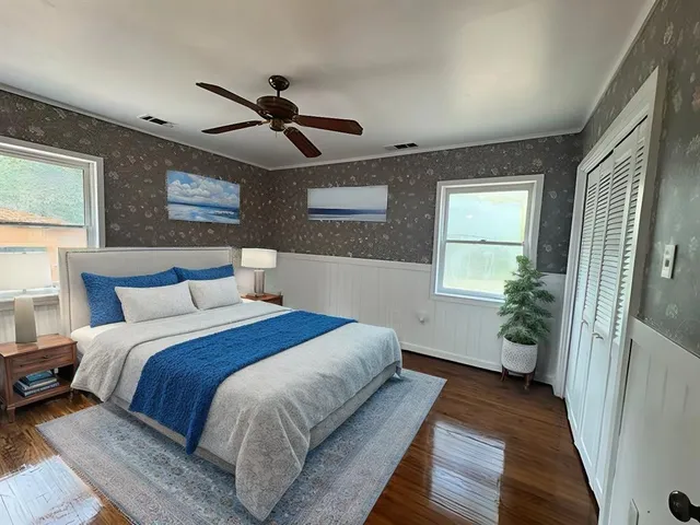 a bedroom with a bed and a window